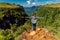 Hiker woman enjoying on cliff in Canyon park in Santa Catarina, Brazil