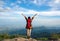 Hiker woman feeling victorious facing on the mountain