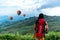 Hiker woman feeling victorious facing and seeing balloon