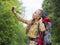 Hiker woman make a selfie with mobile phone.