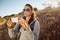 Hiker woman taking photographs with her smartphone