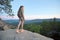 Hiker woman walking on mountain footpath enjoying evening nature. Lonely female traveler traversing wilderness trail