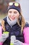 Hiker woman warming up drink tea in cold day