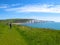 Hikers approach white cliffs of Seven Sisters, East Sussex, England