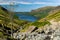 Hikers ascending England\\\'s talltest mountain, Scafell Pike via Wasdale Head with Wastwater in