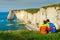 Hikers with backpack, enjoying the ocean, Etretat, Normandy, France