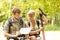 Hikers backpackers couple reading map on trip.