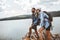 Hikers with backpacks on cliff enjoying at the mountain lake