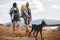 Hikers with backpacks and their doberman walking enjoying at the mountain lake