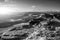 Hikers in beautiful black and white Peak District landscape during autumn sunset