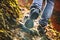 Hikers boots on forest trail. Autumn hiking.