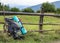 Hikers camping backpack leaning on old wooden fence. Tourist equipment