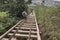 Hikers climbing down wooden rail cart bridge of KoKo Crater, Oahu