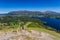 Hikers climbing the hill at Catbells overlooking Derwentwater and the town of Keswick in the
