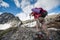 Hikers are climbing rocky slope of mountain