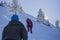 Hikers climbing snow covered winter trail