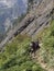 Hikers climbing steep mountain trail