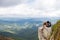 Hikers couple camping on rocks nature. Romantic lovers on vacation camping. Panoramic mountains landscape.