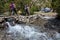 Hikers crossing river