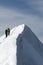 Hikers on a dangerous snow-covered ridge