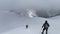 Hikers Descend From The Mountain To The Forest Area On A Winter Hike