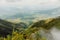 Hikers dwarfed by the mountain landscapes at Mount Sabyinyo in the Mgahinga Gorilla National Park, Uganda