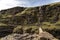 Hikers exploring beautiful Icelandic landscape. Crossing simple bridge in the mountains