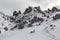 Hikers footpath below rocky cliffs in wintertime