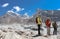 Hikers with guide stands on glacier in Himalayas
