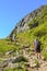 Hikers with hiking poles in French Alps near Chamonix on a trail to Lac Blanc with Mont Blanc view. Beautiful Alpine