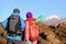 Hikers looking at view pointing hiking in mountain