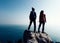 Hikers looking at the view on seaside mountain top rock edge