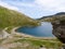 Hikers relaxing by Glaslyn lake at the foot of Mount Snowdon