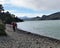 Hikers on a rocky lake beach on the W Trek in Torres del Paine NP in Patagonia, Chile
