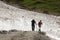 Hikers between snow in Koednitz Valley, Austria