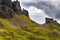 Hikers on a spectacular remote, rocky landscape with a low, moody sky Quiraing, Isle of Skye