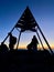 Hikers standing on top of Djebel Toubkal, highest mountain of Morocco, at sunrise. Vertical close up.