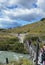 Hikers on a suspended bridge over a glacier fed stream in Torres del Paine National Park, Patagonia Chile