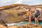 Hikers - travel couple tourists hiking on Hawaii. Tourist backpackers walking on Green Sand Beach, Papakolea on Big