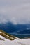 Hikers traversing a glacial snow mountain trail