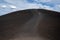 Hikers walk down from the Inferno Cone at Craters of the Moon National Monument