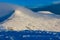 Hikers and walkers on a cold, snow covered mountain in the early morning sunshine Pen-y-Fan