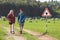 Hikers walking past tick Infected area with danger sign