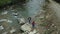 Hikers walking river aerial view close mountain road among green forest trees