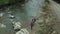 Hikers walking river aerial view close mountain road among green forest trees