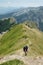 Hikers Walking On Trail Of Mountain Ridge, Montenegro