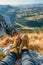 Hiking Adventure Panorama Close Up of Feet with Hiking Shoes from a Young Woman Resting on Top of a High Hill or Rock, Landscape