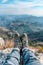 Hiking Adventure Panorama Close Up of Feet with Hiking Shoes from a Young Woman Resting on Top of a High Hill or Rock, Landscape