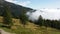 Hiking in austria with clouds over trees