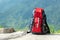 Hiking backpack travel gear on mountain. Items include hiking